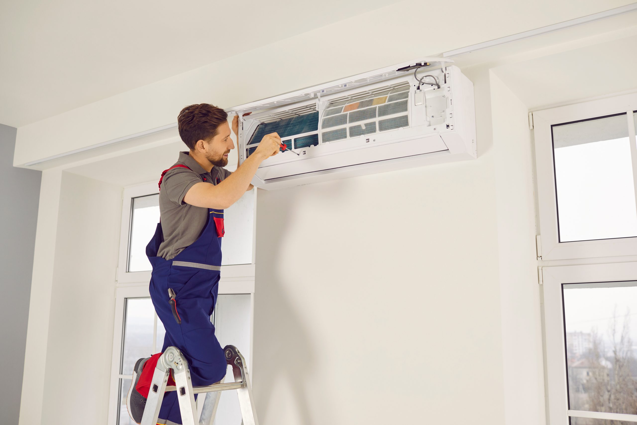 Homme réparant une climatisation